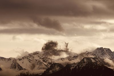 Scenic view of snowcapped mountains against sky during sunset