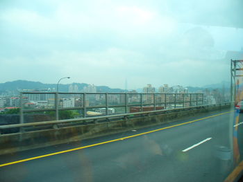 Empty road with bridge in background
