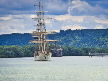 Sailboat sailing on seine river against sky, during armada exhibition 