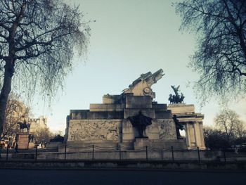 Low angle view of statue against trees