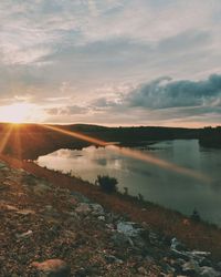 Scenic view of lake against sky during sunset