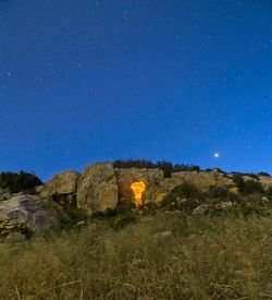 Scenic view of field against clear sky at night