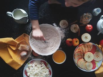 Directly above shot boy preparing food on table