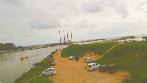 High angle view of cars on shore against sky