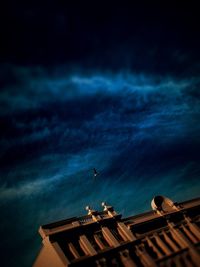 Low angle view of building against cloudy sky