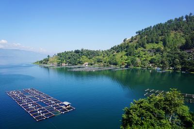 Scenic view of toba lake against blue sky