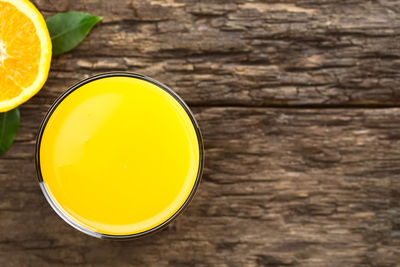 High angle view of yellow drink on table