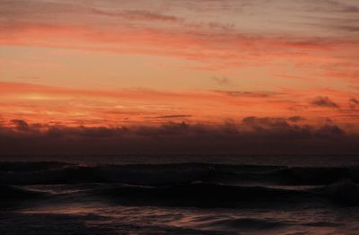 Scenic view of sea against romantic sky at sunset