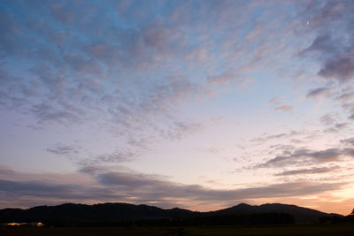 Scenic view of silhouette mountains against sky during sunset