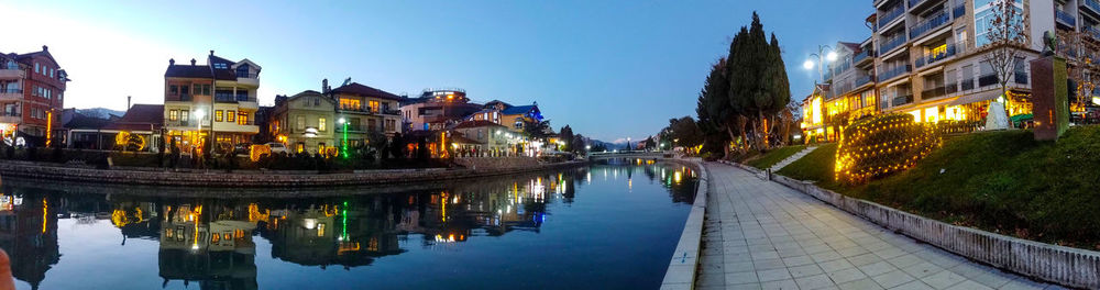 Reflection of buildings in city at waterfront