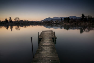 Pier over lake against sky