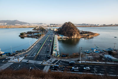 High angle view of river by city against clear sky