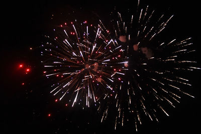 Low angle view of firework display at night