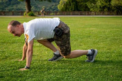 Side view of two men on grassland