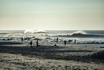 People on beach against sky