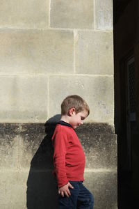 Boy standing against wall