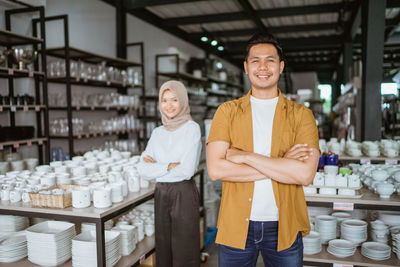 Portrait of young man standing in store