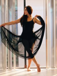 Woman with arms raised in city