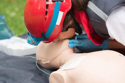 Healthcare worker practicing on cpr dummy at park