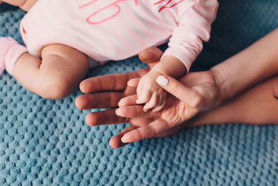 Father and mother hold in their hands a little baby's.