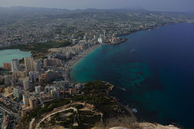 High angle view of city by sea against sky