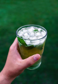 Cropped image of person holding drink