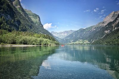 Scenic view of lake and mountains against sky