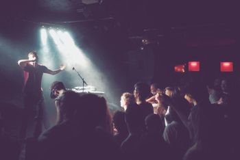 REAR VIEW OF PEOPLE ENJOYING MUSIC CONCERT