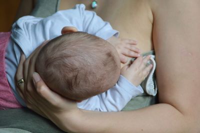 Close-up of mother feeding baby