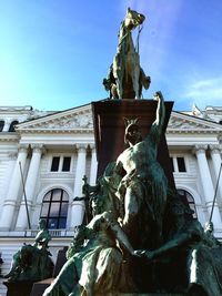 Low angle view of statue against blue sky