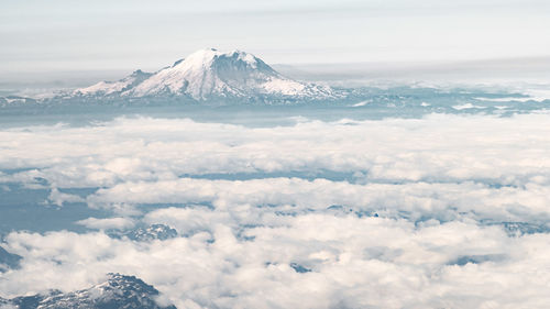 Aerial view of snowcapped mountains against sky
