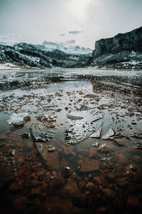 Scenic view of lake against sky during winter