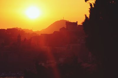 Silhouette of city during sunset