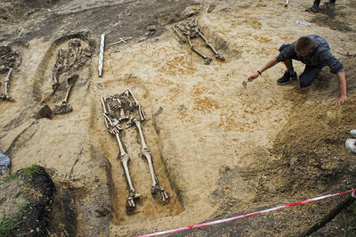 High angle view of man working at graveyard