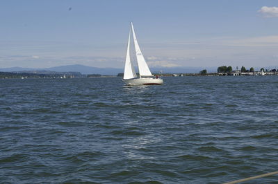 Sailboat sailing on sea against sky