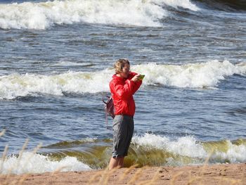 Full length of man standing on beach