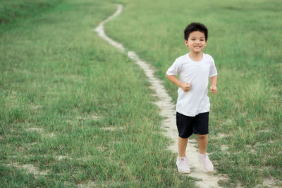 Boy standing on field