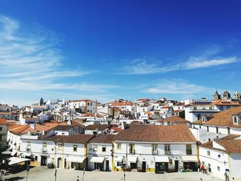 High angle view of townscape against blue sky