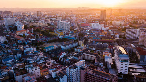 High angle view of buildings in city against sky during sunset