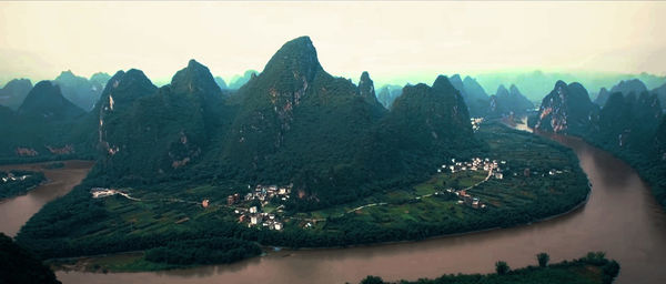 Panoramic view of trees and mountains against sky