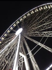 Low angle view of ferris wheel at night