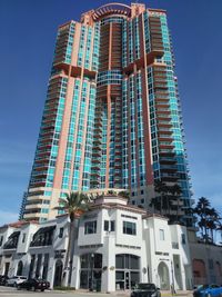 Low angle view of modern building against blue sky