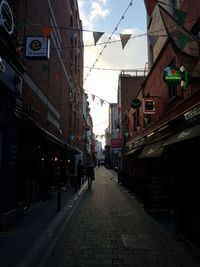 Street amidst buildings against sky in city