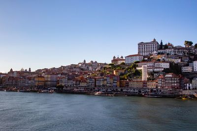 Town by sea against sky in city