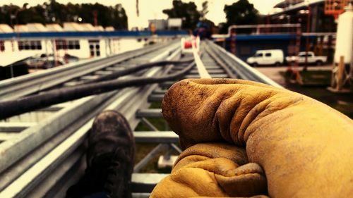 Close-up of man sitting on railroad track