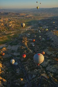 Hot air balloons flying over lake