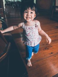 Portrait of a smiling girl lying on floor at home