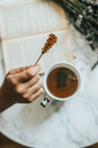 Image of hand holding tea cup