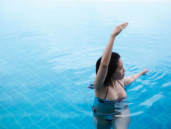 Woman standing in swimming pool