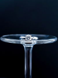 Close-up of water splashing in glass against black background